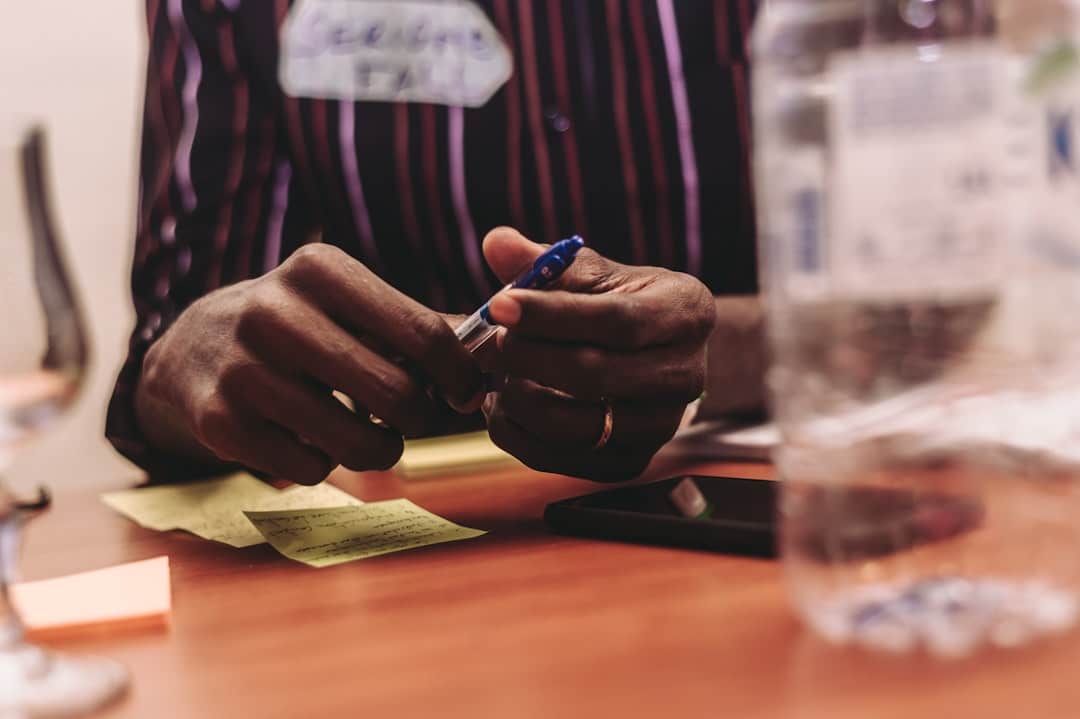 A focused, macro shot of a person's hand using an elegant pen to sign a signature line on a formal contract, symbolizing a legal commitment.