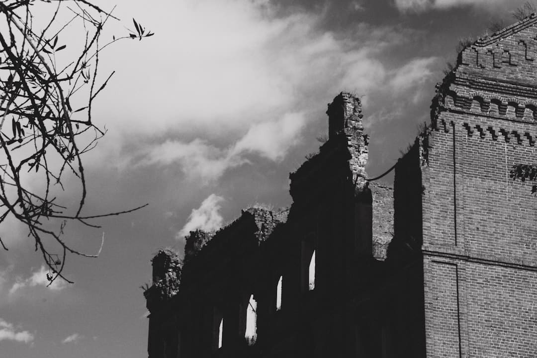 A historic Southern home with dramatic shadows, evoking a sense of mystery and the potential for hidden problems in a real estate title.