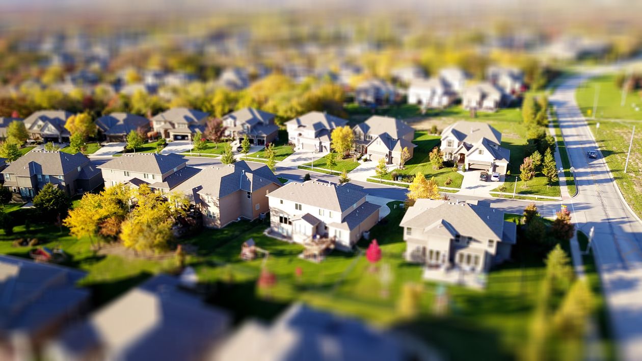 A piggy bank and a set of house keys resting on a clean, bright surface, symbolizing the financial savings achieved through a homestead exemption.