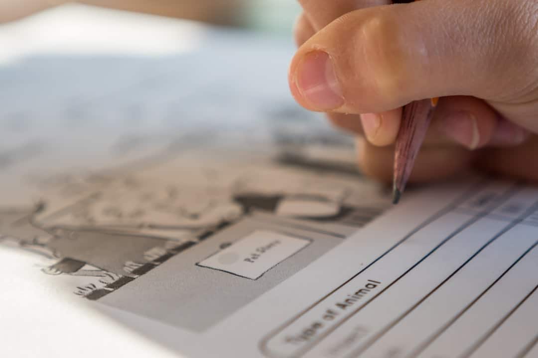 A close-up shot of a homebuyer's hands signing official closing documents with a pen, symbolizing the final steps of title transfer and closing costs.